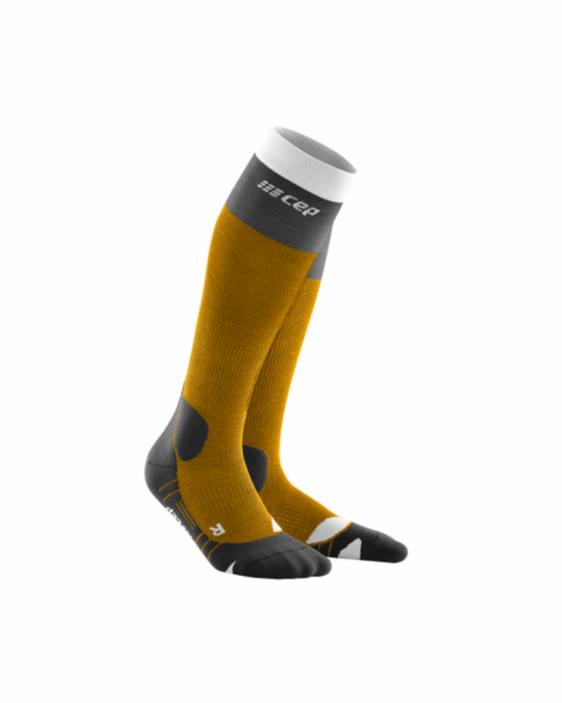 Knee-high compression socks in yellow and grey with a white cuff.