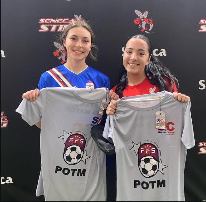 Two female soccer players holding 'Player of the Match' (POTM) shirts at a Seneca Sting event, featuring FFS and SkipperChoice branding